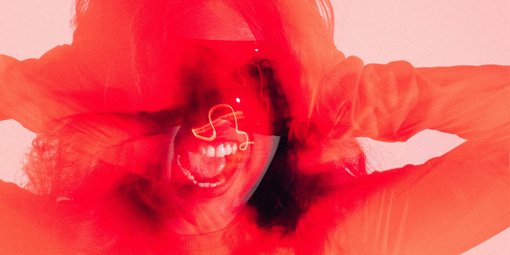 Woman holding her head and screaming