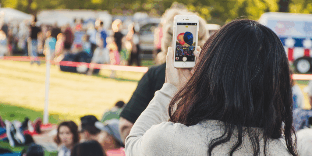 data privacy image showing a woman recording a public event