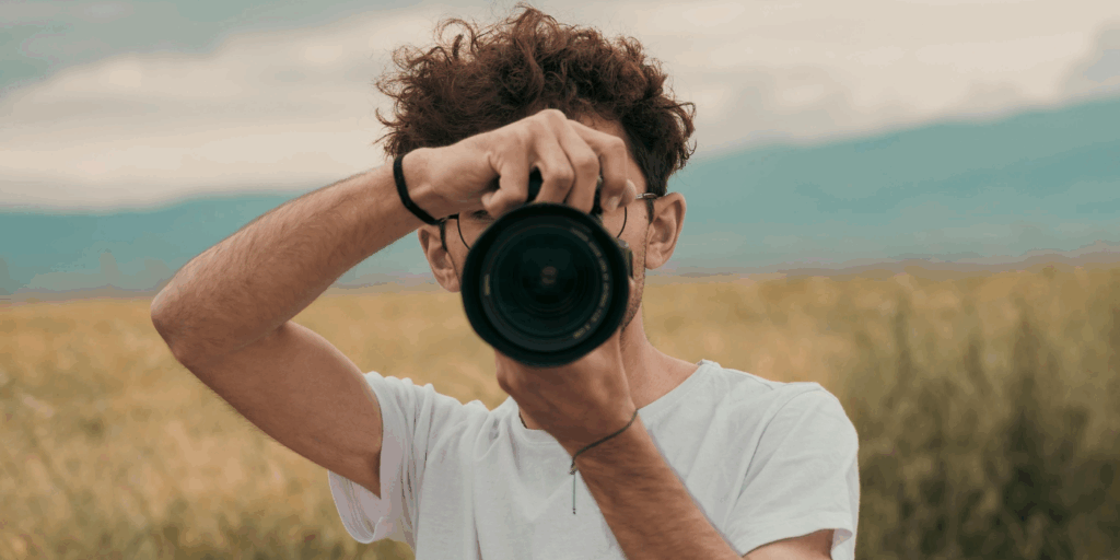 man with a camera pointing at the screen to symbolize data privacy