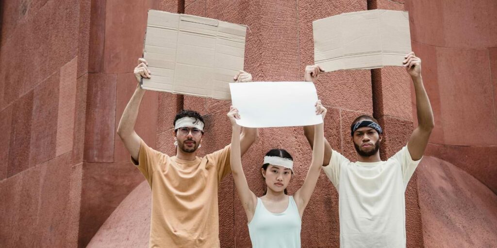 protestors holding up blank signs to represent the loss of American rights