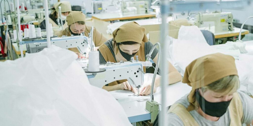 Image of factory workers sewing for AI job displacement analysis