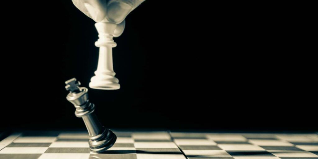 Image of dehumanization depicted by power shown through chess pieces