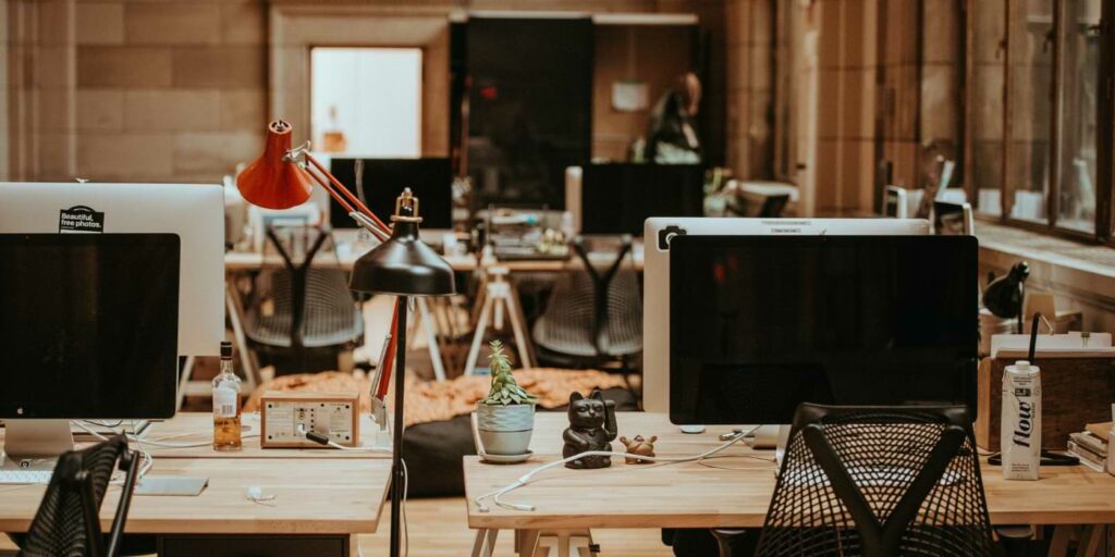 Forever layoffs image showing an empty office filled with computers